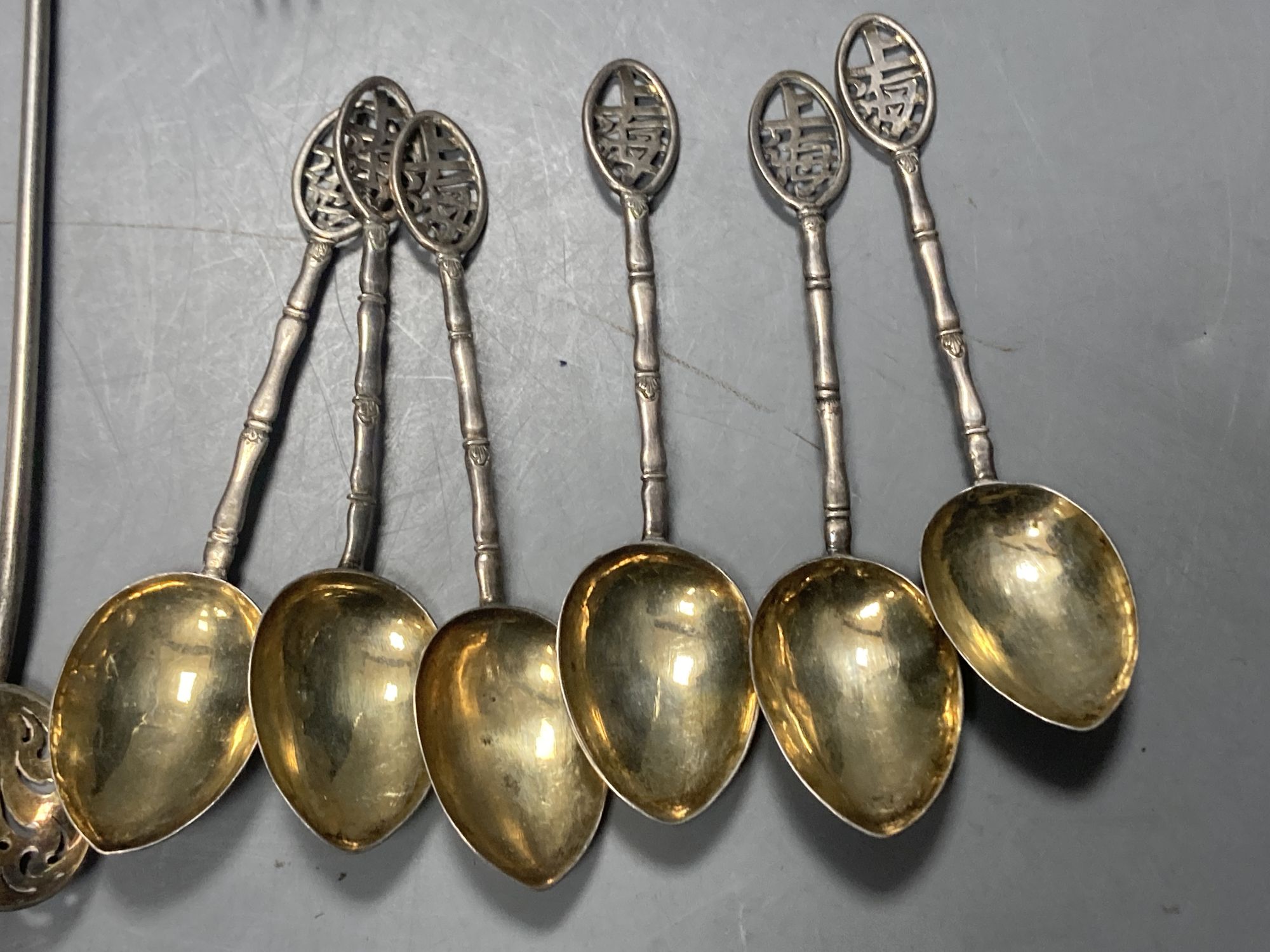 A group of assorted Chinese white metal spoons and forks, including set of six teaspoons and ten small items of English silver.